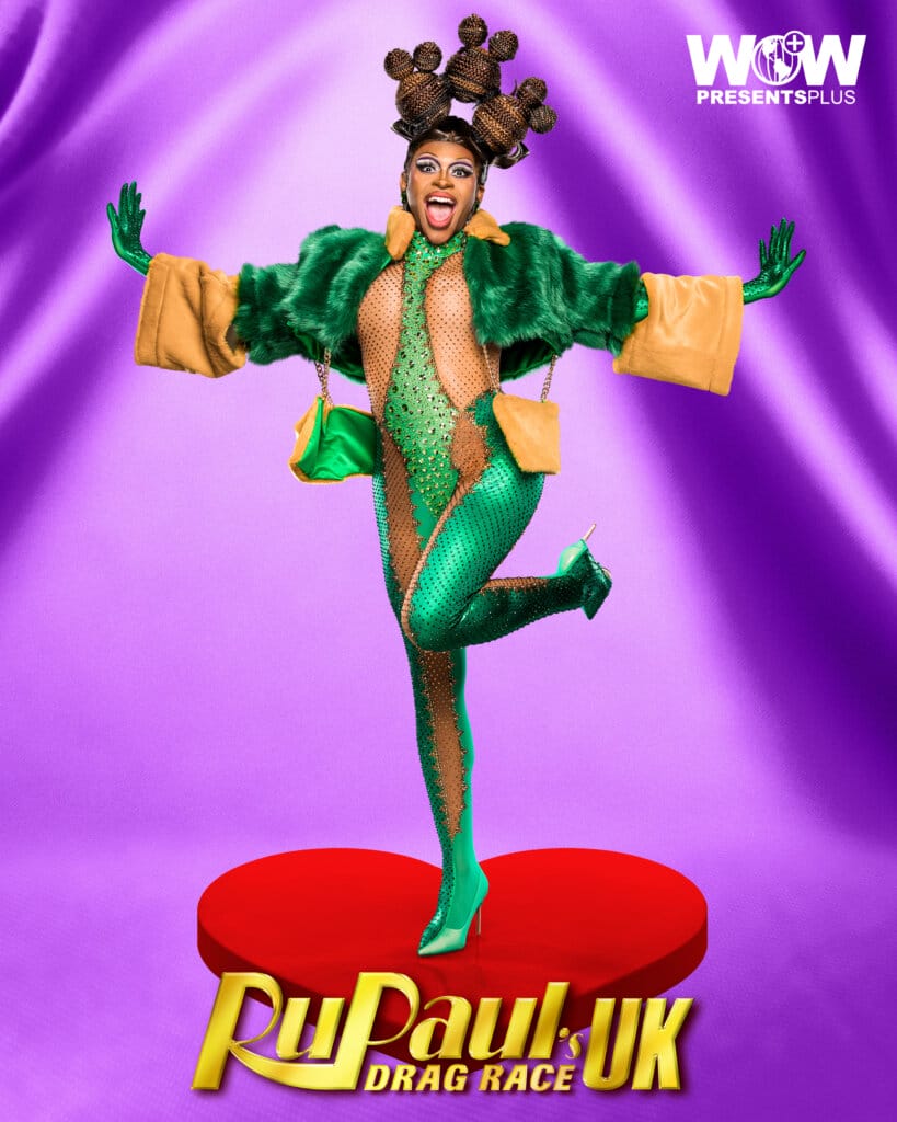 RuPaul's Drag Race UK Series 5: Comedy Challenge and a Surprise Exit 28 Miss Naomi Carter posing for RuPaul's Drag Race UK series 5 promo for Meet The Queens in a green outfit.
