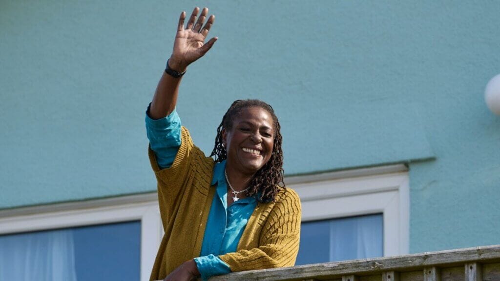 Still from "Lost Boys & Fairies" by the BBC which sees Sharon D Clarke waving from a balcony.