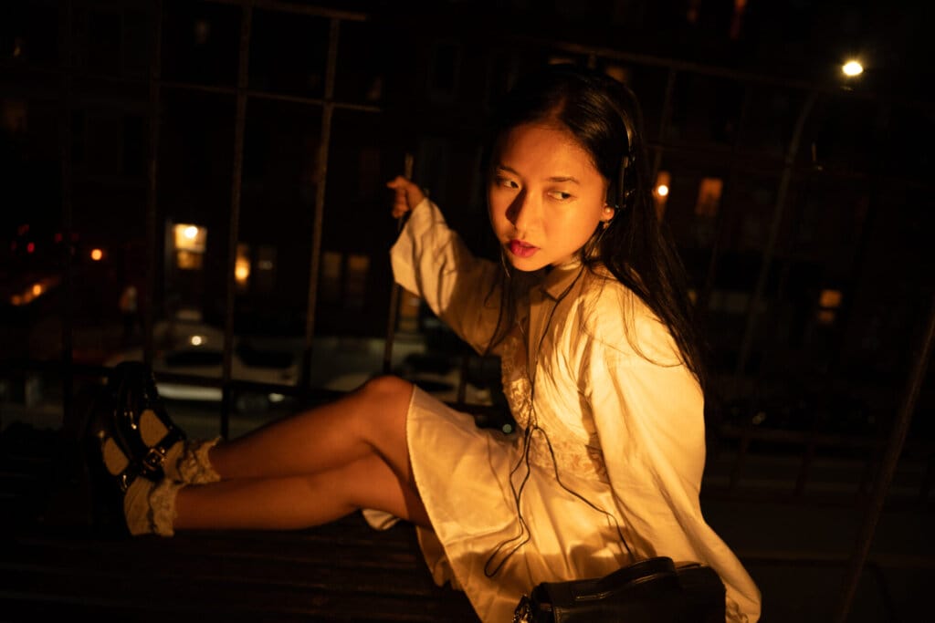 ÊMIA Unveils Sensational Sequel EP "VIDEO CALL: PM" - A Captivating Musical Journey of Emotions and Connection 69 Promotional image for "VIDEO CALL: PM" which sees ÊMIA posing at night with the New York skyline behind her, on the floor.