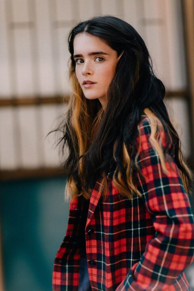 Exclusive Interview: Belle chats about "Beautiful To Me", her music career, and being a rising star 82 Belle wearing a red and black checkered shirt, standing to the side and with her head tilted towards the camera.