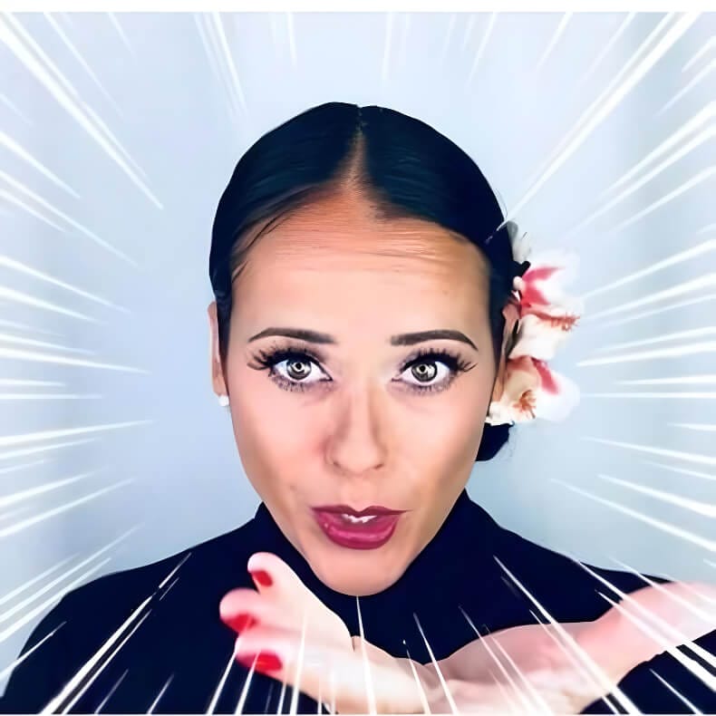 Promotional headshot photo of Lolly posing with slick back hair and a flower tied in, with her make-up on point.