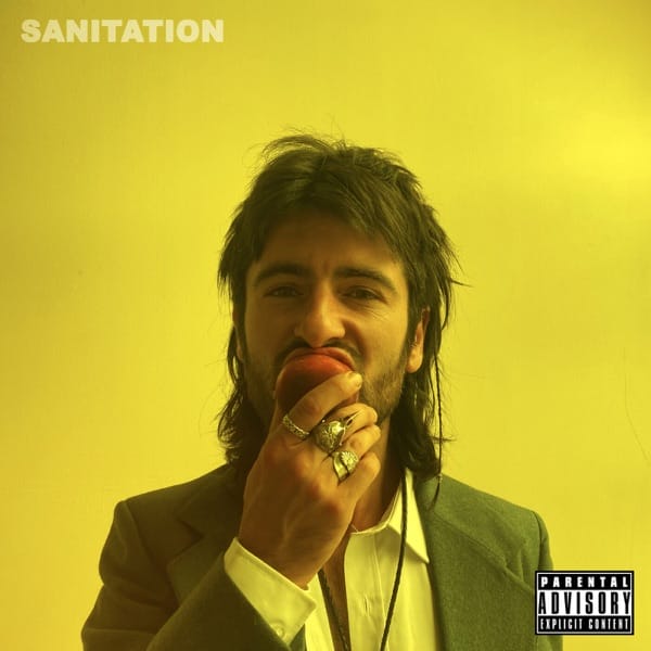 Official single cover artwork for "Sanitation" by The Gulls which sees a man with a mullet taking a bite out of an apple. The image has a yellow filter to it, making the background a bright lemon yellow.