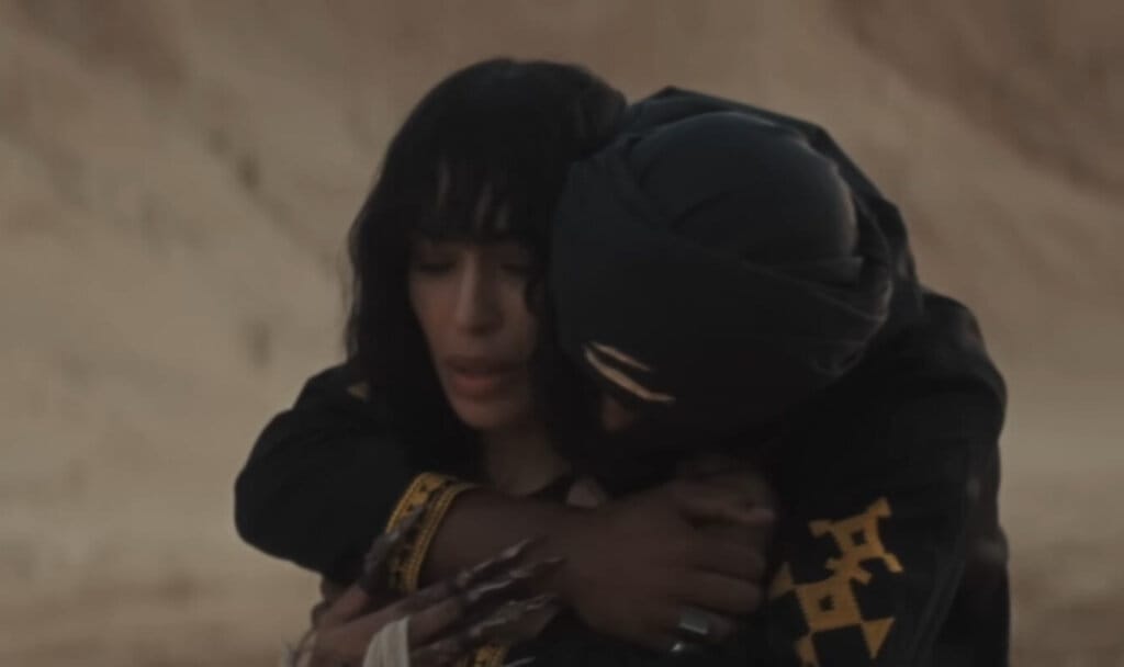 Loreen Captivates In Gorgeous Desert Scenery Music Video For "Is It Love" 28 Still from the "Is It Love" music video which sees Loreen being embraced by her love-interest, calming her anxiety around whether it is love or not.
