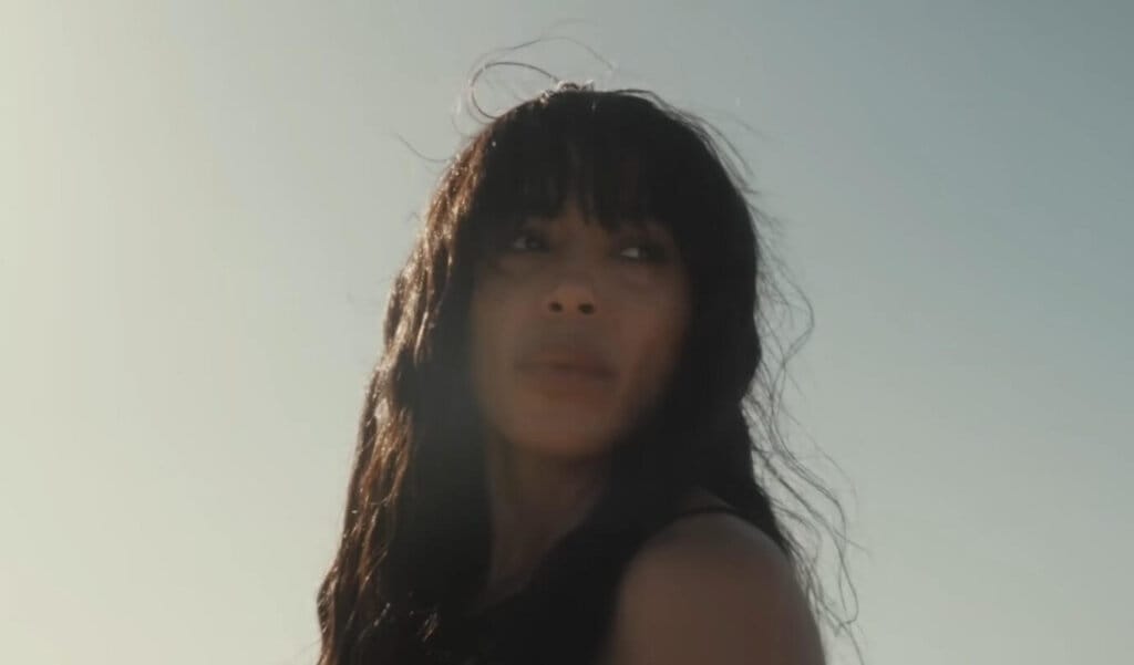 Loreen Captivates In Gorgeous Desert Scenery Music Video For "Is It Love" 18 Still from the "Is It Love" music video which sees Loreen looking off to the distance with the sunny sky behind her.
