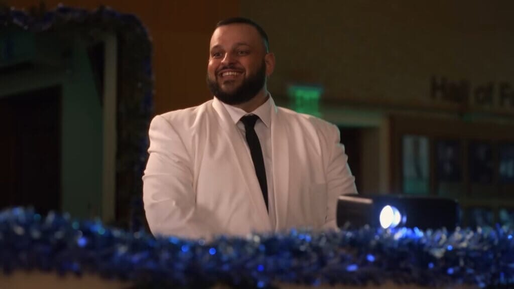 Walmart's Mean Girls Reunion with Lindsay Lohan, Amanda Seyfried, and Lacey Chabert: A Jaw-Dropping Fetch Black Friday Delight 7 Still from Walmart's Mean Girls reunion advert which sees Daniel Franzese controlling the lights at the Winter show.