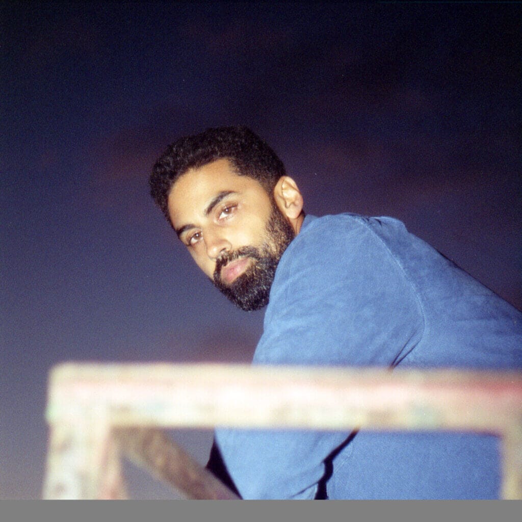 "Loveless Love": Action Forever Unveils Riveting New Single 2 Official single cover artwork of "Loveless Love" by Action Forever which sees Sim looking at the camera over his shoulder as he sits at a wooden bench, wearing a blue denim jacket.
