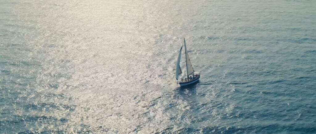 Scene from the "I GOT YOU" music video which sees the boat sailing away across the sea.