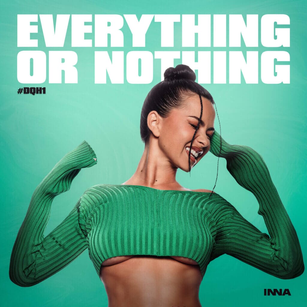 Everything or Nothing: INNA Proves She's the True Dance Queen With New EP Featuring Songs Created During Season 4 of Her YouTube Series 42 Official album artwork for the EP "Everything or Nothing" which sees INNA wearing a green crop-top jumper that shows under boob, with her head turned to the right with a grin on her face, full of happiness, as a line of hair falls down her face, while the rest of her hair is in a bun.