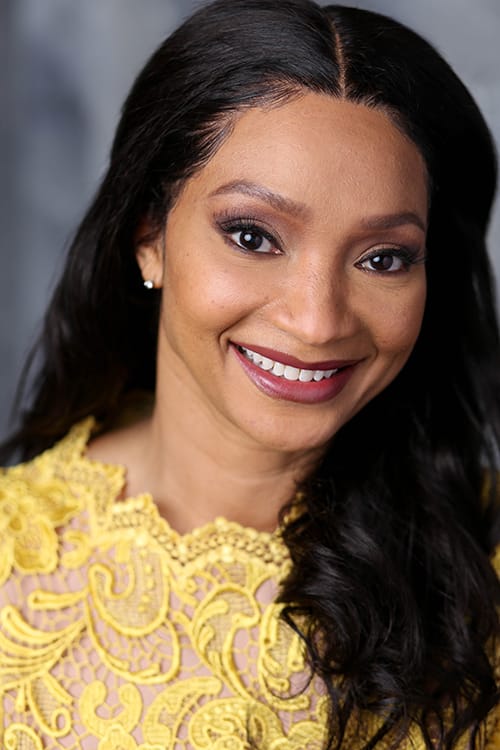 Shene Commodore: Inspiring Women On and Beyond the Silver Screen 2 Shene Commodore posing for an actress image head shot which sees her smiling while wearing a yellow top and her black hair cascading down her left shoulder and down her back.