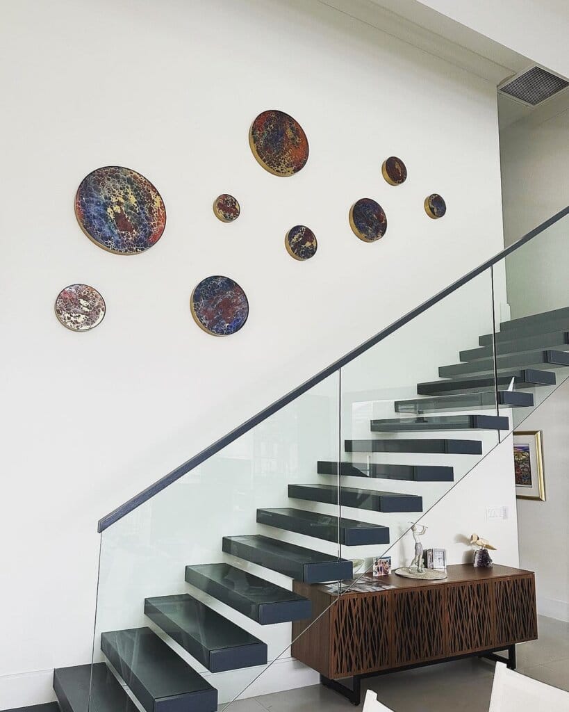 From Dreams to Art Masterpieces: Rick Lowe Art Inspires Creativity With Waves of Passion and Purpose 3 Some of Rick Lowe's circle-themed artwork hanging above a staircase.