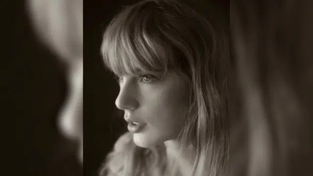 Black and white head-shot photo of Taylor Swift looking to the left.