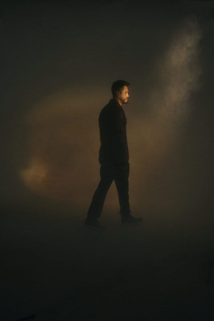 Wils Releases Final Single "Dancing Lights" Marking the End of a Musical Era 11 Promotional photo for "Dancing Lights" which sees Wils walking away in a light airy smoke as a subtle light can be seen from the top.