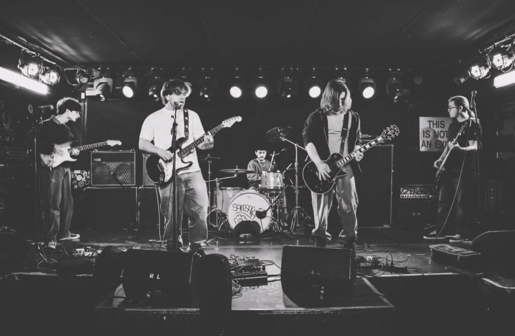 SAMSARA. to Rock the Northeast With Major Summer Performances 10 Black and white photo of SAMSARA. performing on stage.