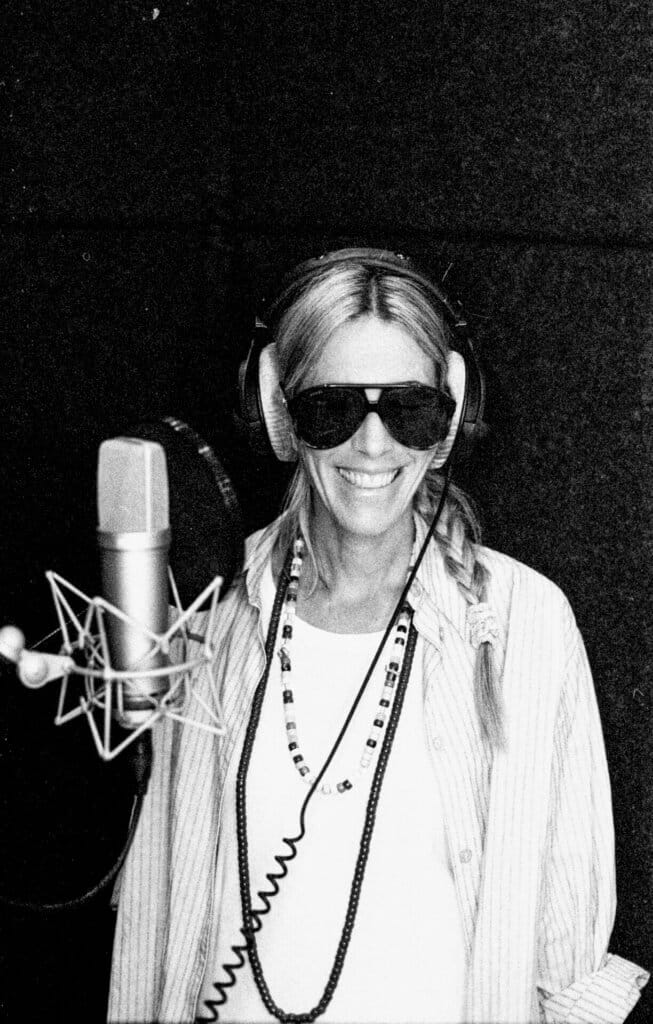 Bird Stuns at Intimate Showcase Event for Her Short Film "Wider Than The Sky" Alongside The Album Release at Everyman Cinema, King's Cross, London 27 Black and white photo of Bird in the studio with headphones on, shades and standing in front of the microphone.