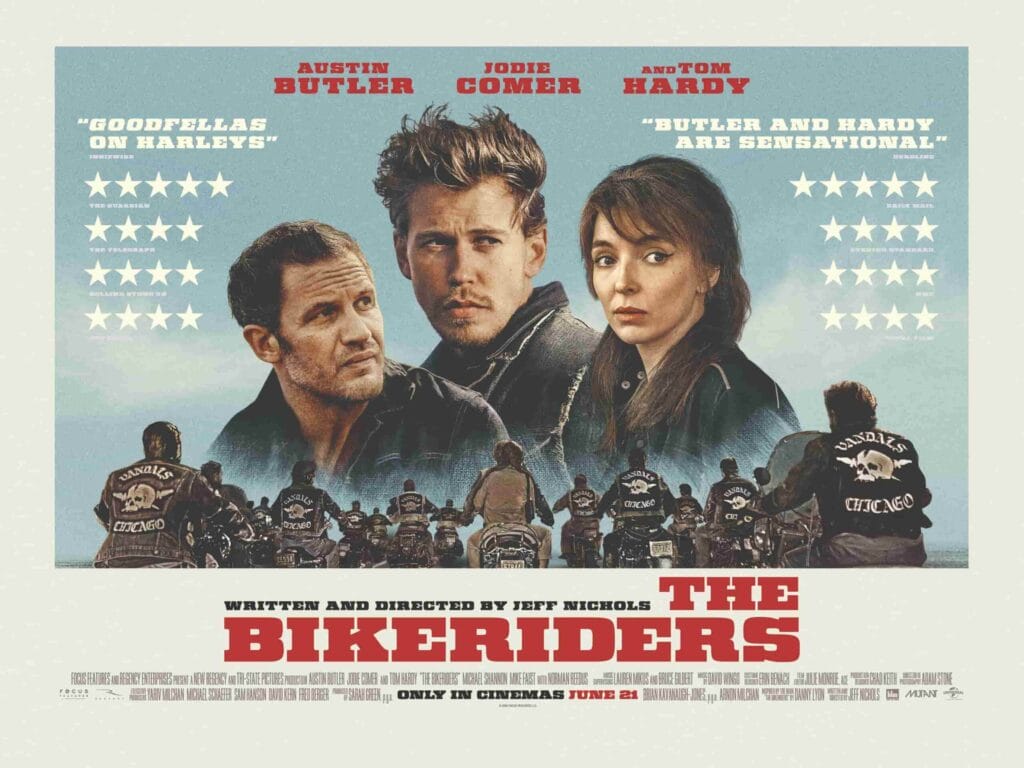 The Bikeriders Film Review: Jodie Comer Commands the Screen Through A Journey of Rebellion and Loyalty 11 Official cinema landscape poster for The Bikeriders that sees the official photo of Tom Hardy, Austin Butler, and Jodie Comer with the row of motorcyclists riding, surrounded by a cream boarder and announcing the star ratings from magazines.