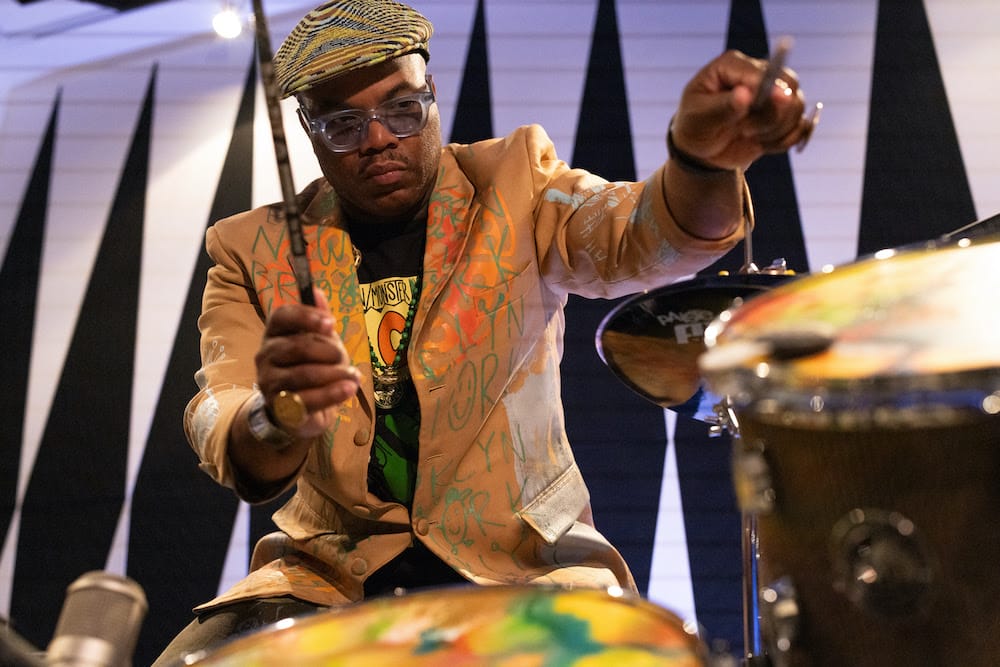 Cardboard Sessions: A Symphony of Cardboard Creativity Continues with GRAMMY-Award Winner Daru Jones 20 Daru Jones playing the Cardboard Sessions drums with the drumsticks in his hands.