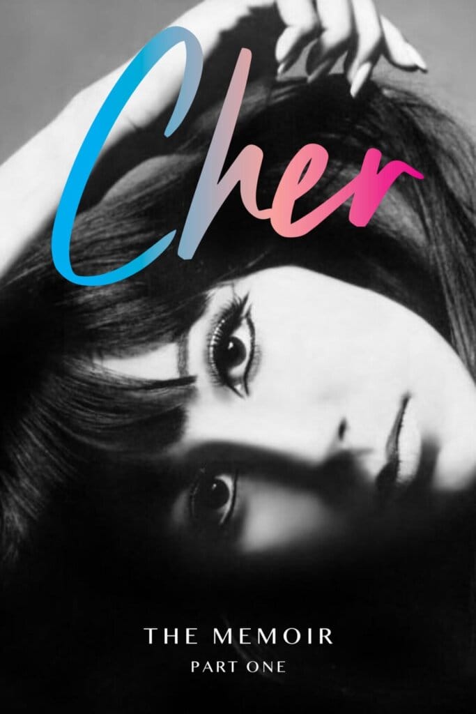 Official book cover of "Cher: The Memoir, Part One" which shows a close-up of the face of a young Cher looking at the camera, lying on her side with an arm behind her head. It is in black and white, apart from Cher's name which is an ombre from blue to pink.