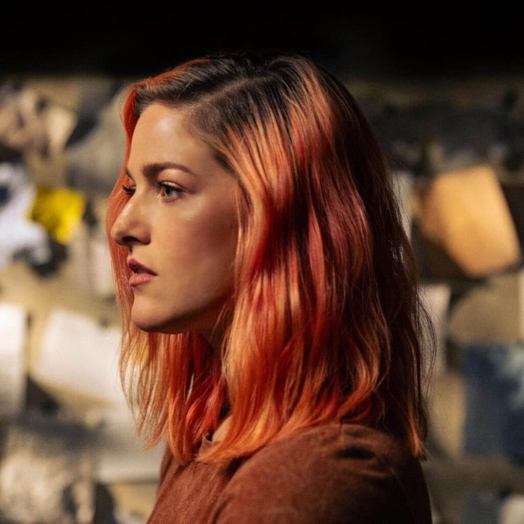 "Hereditary" Unleashed: Cassadee Pope Reclaims Rock Throne With Bold Pop-Punk 12-Track Album Masterpiece 38 Single cover artwork for "Three of Us", which sees Cassadee Pope facing to the left as her copper hair fall just past her shoulders.