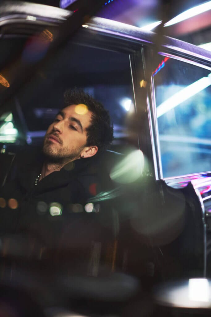 "Other People": The Heartfelt Journey of Loss and Reflection in Daniel Arison's New Single and Music Video 3 Photo which sees Daniel Arison relaxinging in the front-seat of a car.