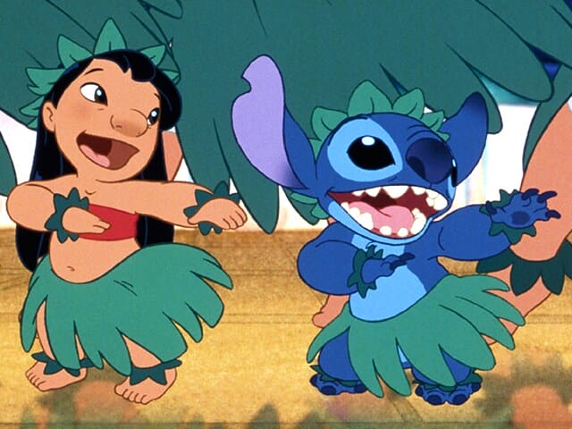 Disney Reveals First Look at CGI Stitch for Upcoming 2025 "Lilo & Stitch" Live-Action Film 66 Still from the 2002 Disney "Lilo & Stitch" film which sees Lilo and Stitch dancing in hula skirts.