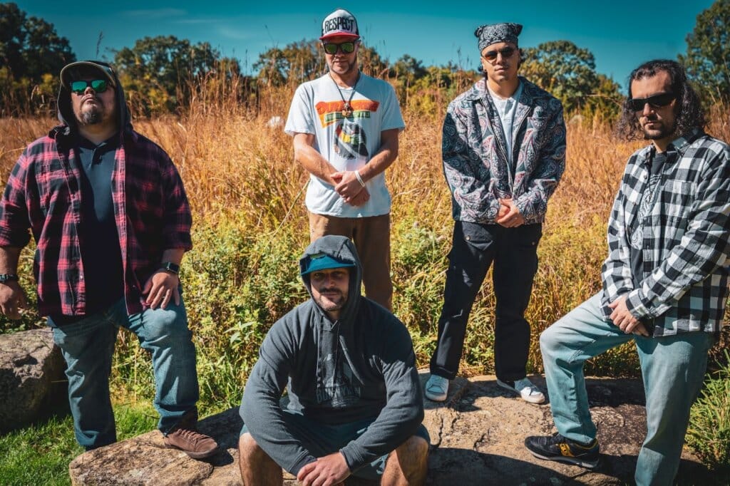 IRIEspect’s Debut Album: A Bold Fusion of Reggae Rock and Genre-Bending Sounds 3 Group photo of IRIEspect standing apart from one another with a field behind them.