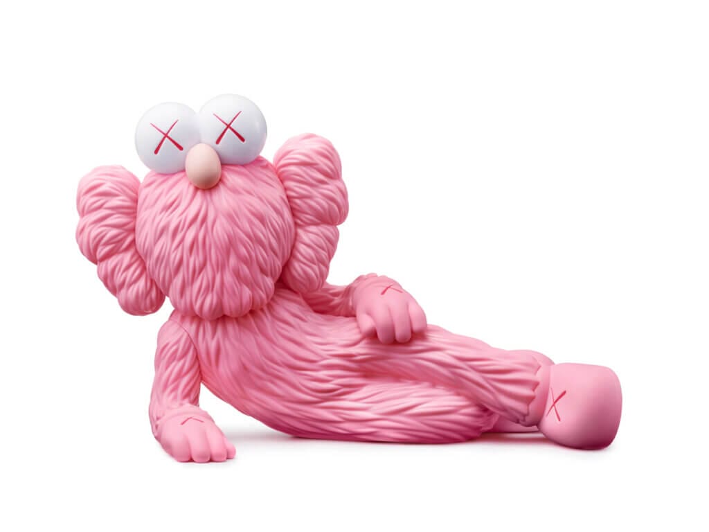 Crystal Bridges Museum Announces KAWS: FAMILY Exhibition for 2025 10 Image of KAWS: TIME OFF which shows a pink figure lying on their side.