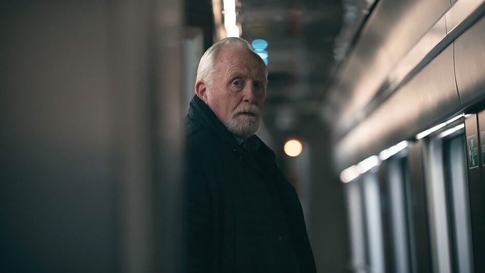 Still from the Nightsleeper trailer which sees an old man (James Cosmo) looking down the train corridor.