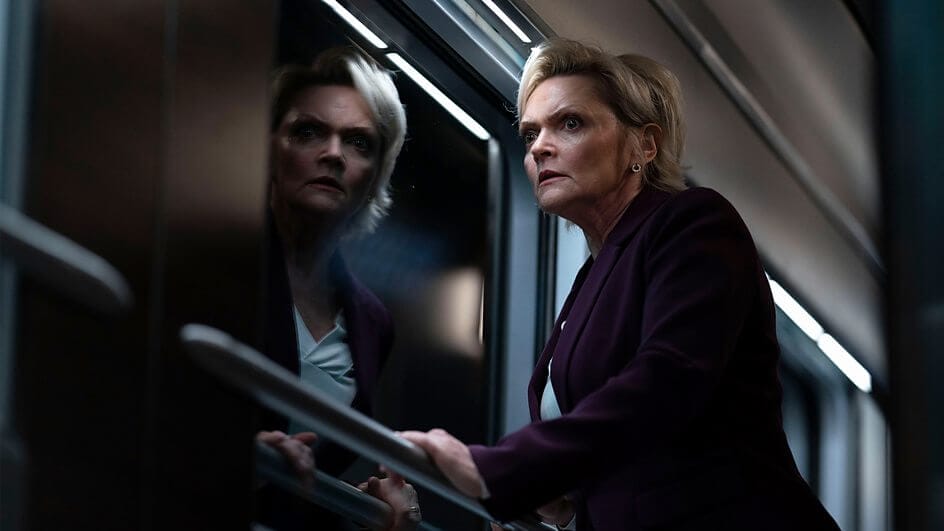 Still from Nightsleeper trailer which sees a woman (Sharon Small) with short blonde hair looking out the train window.