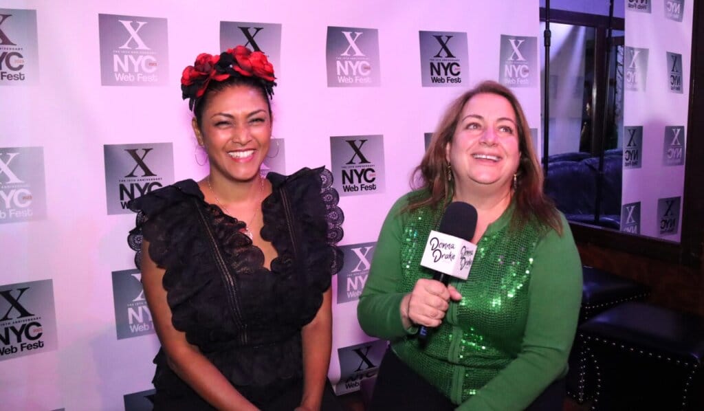 Lauren Atkins being interviewed by Donna Drake at NYC Web Fest with the former wearing a black dress and the latter wearing a green dress.