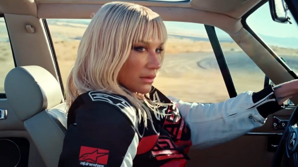 Still from "Joyride" music video which sees Kesha driving a car, escaping assassins.