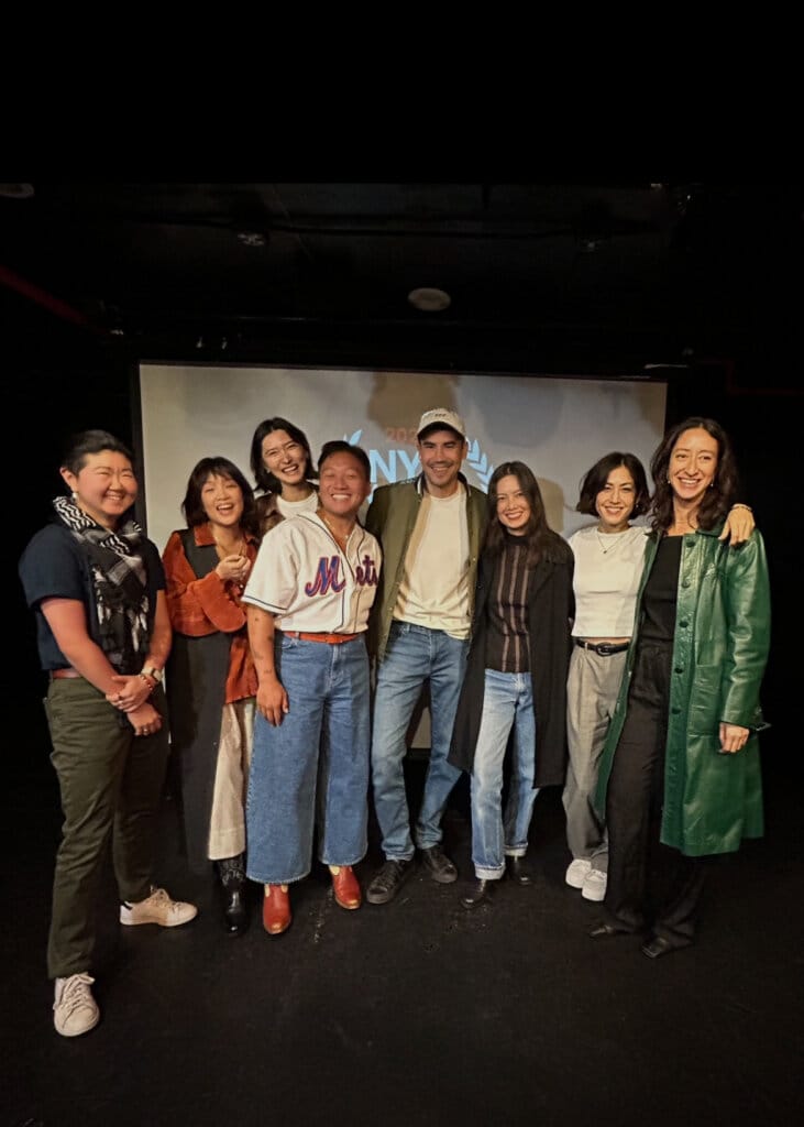 The cast and crew of Future Proof posing in front of a screen who were NYC Web Fest 2024 Award Winners