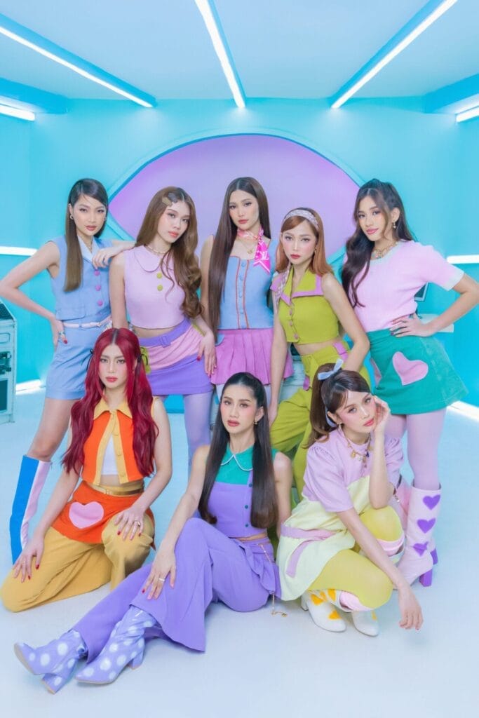 The eight-piece girl group, BINI, posing together in pastel colours on a pastel-blue set.