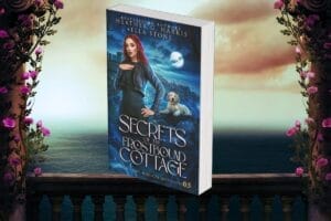 Background image shows a fantasy-themed balcony overlooking the ocean with pink flowers draping the sides, while the foreground image shows the Heather G. Harris and Ella Stone book "Secrets of the Frostbound Cottage" which has a blue theme to it and shows a red-headed woman who we presume is Beatrix with a Labrador dog behind her.