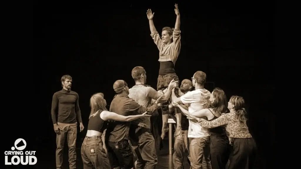 A black and white promotional image for the circus performance show of InThisTogether where we see a group of people holding up a woman.