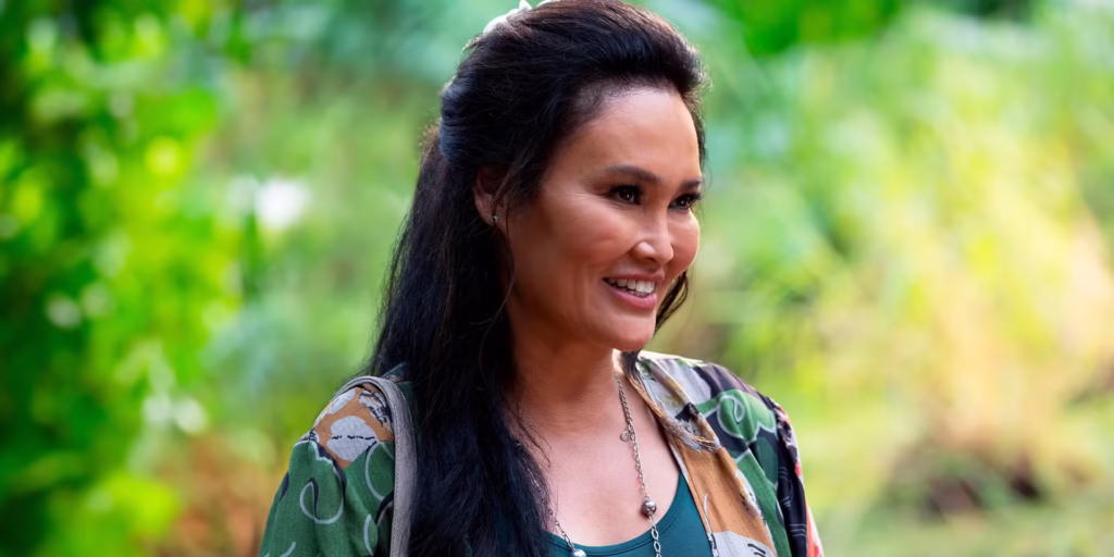 Film Review: Disney’s Lilo & Stitch (2025) Is a Nostalgic Journey That Will Make You Laugh, Cry, and Believe in ‘Ohana All Over Again 69 Mrs. Kekoa arriving at Nani and Lilo's home. She's smiling and there's greenery in the background.