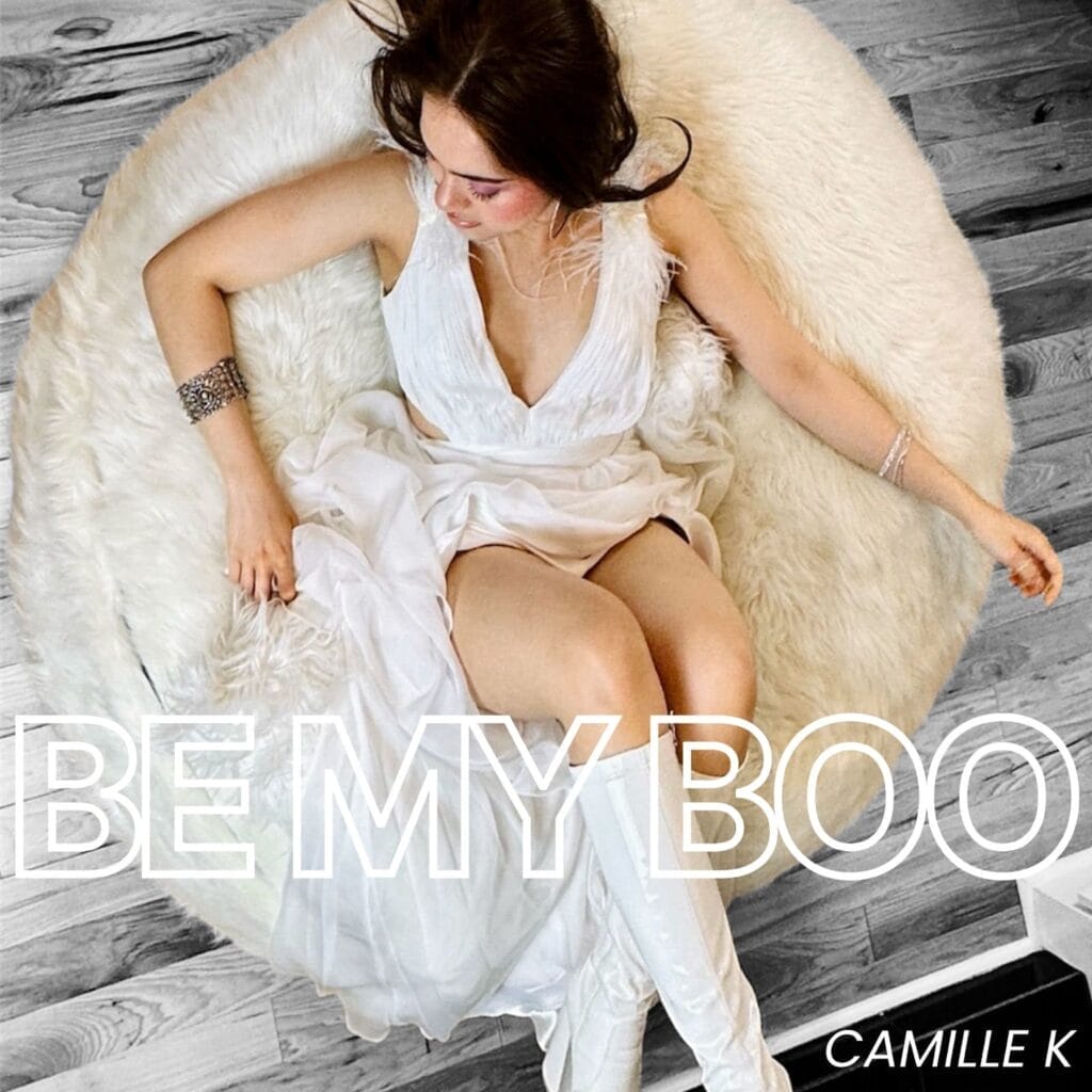 Official single cover artwork for "Be My Boo" which sees Camille K sitting on a cream-coloured fluffy beanbag chair, dressed in white.