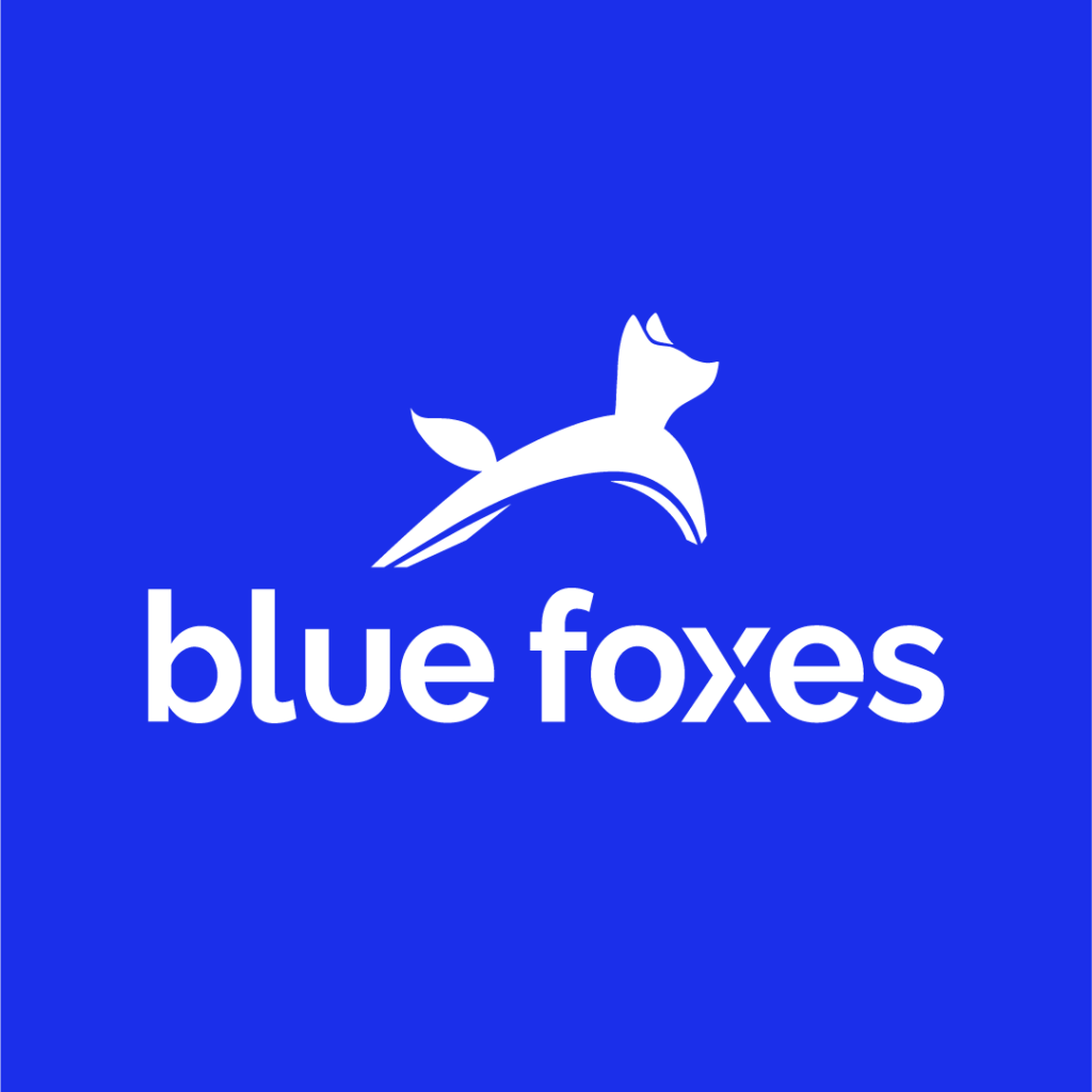 The official logo for Blue Foxes which shows a white fox with the brand's name underneath in white, against a bright blue background.