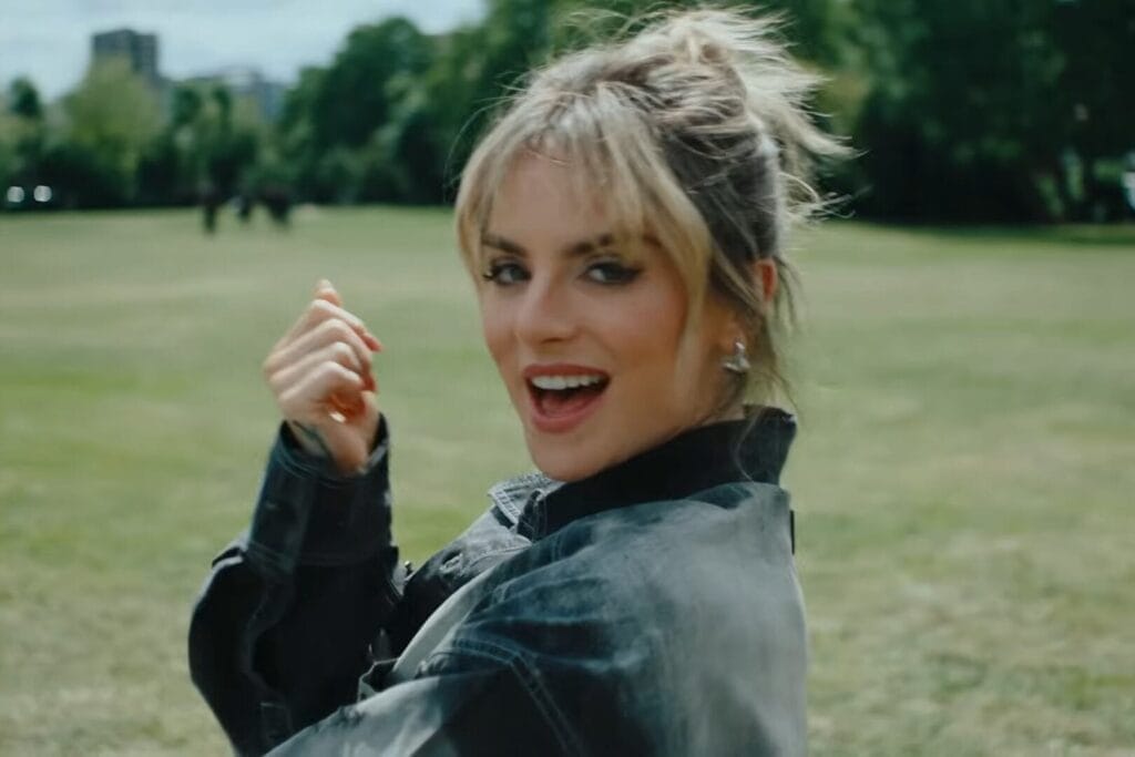 Screenshot from the "In It With You" music video which sees JoJo singing the song while looking over her shoulder at the camera.
