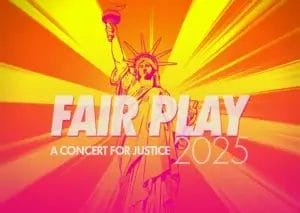 Official banner for the Fair Play: A Concert for Justice 2025 which is an image of the Statue of Liberty with the sun directly behind her blazing sunrays all around her. The image is filtered pink and yellow with the concert name in a translucent grey.