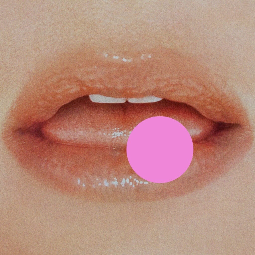 The official album artwork for "." by Kesha which is also known as "Period" where we see a close-up shot of a mouth with a tongue slightly sticking out and a pink big pink dot on the mouth referencing the song's title.