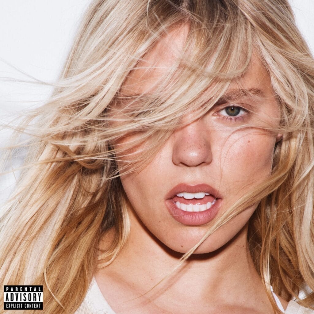 Official album cover artwork for "BITE ME" which "Why Is She Still Here?" is a part of. In the artwork we see a headshot of Reneé Rapp as her blonde hair looks windswept over her face.