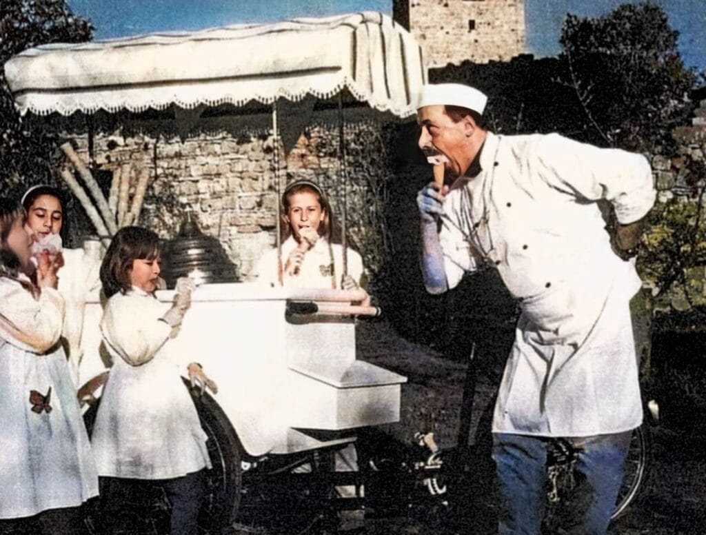 An old photo of Sergio Dondoli with a gelato van showing children how to eat gelato with a cone.