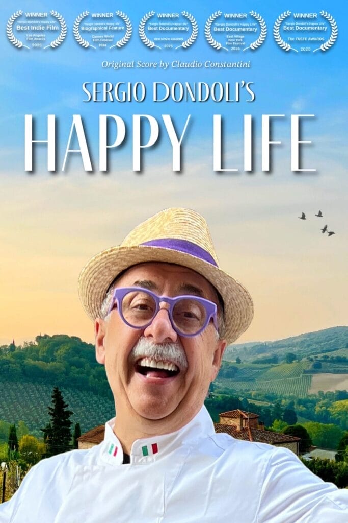Official film poster of Sergio Dondoli's Happy Life which sees Sergio Dondoli wearing a straw hat and a white shirt with purple round glasses, smiling in front of countryside landscape.