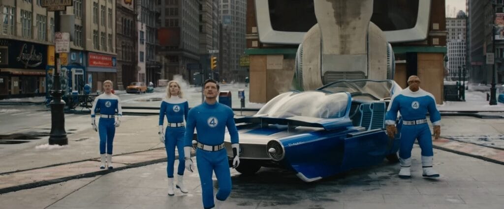 Still from the official trailer of The Fantastic Four: First Steps film where all four main characters are gathering at Times Square, dressed in their blue Fantastic Four uniforms with their blue hovercar behind them.
