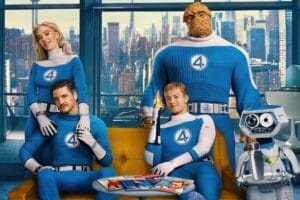 Cropped image of the official The Fantastic Four: First Steps poster where all four main characters are sat on or standing around a couch with H.E.R.B.I.E. the robot. Behind them are tall windows displaying the city of New York.