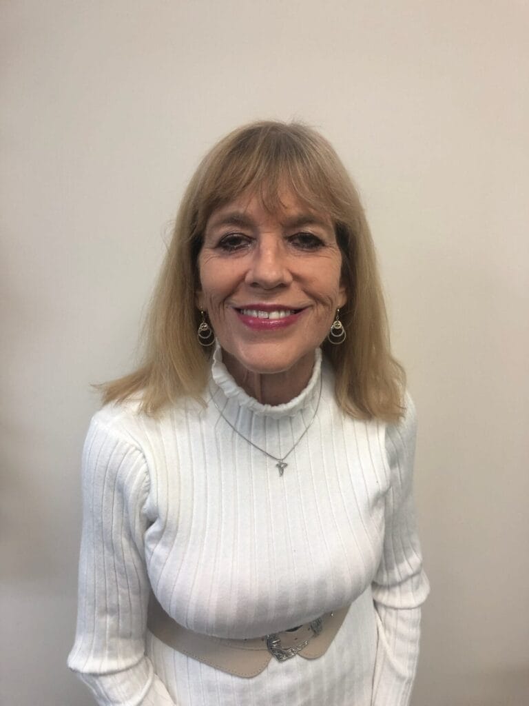 Official author image of Kathryn SchwauSch Branson smiling in a white sweater.