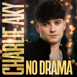 Official EP cover artwork which shows Charlie Aky with dark hair standing in front of blurred lights, conveying a calm vibe. Bold text reads "CHARLIE AKY" on the left styled vertically and "NO DRAMA" horizontally on the bottom, both in gold.