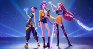 HUNTR/X in futuristic outfits stan=oin ty confidently on a stage. Each holds a glowing weapon, with vibrant colors and a dynamic background.