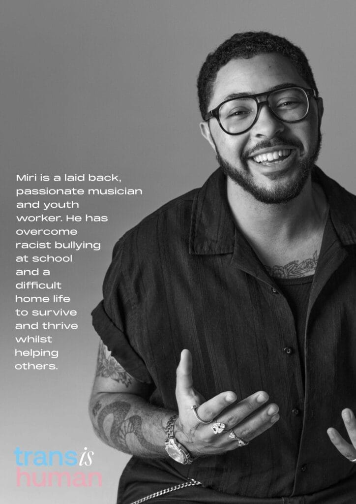 Black and white portrait of Miri smiling with glasses and tattoos. Text beside them highlights their journey overcoming challenges. Keywords: portrait, positive, inspirational.