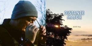Split image: left shows Michael Keane who is the guy behind the project Distance Major, wearing a beanie adjusting glasses, set against a blurred outdoor background; right shows a serene sunrise over misty hills with "Distance Major With You" text.